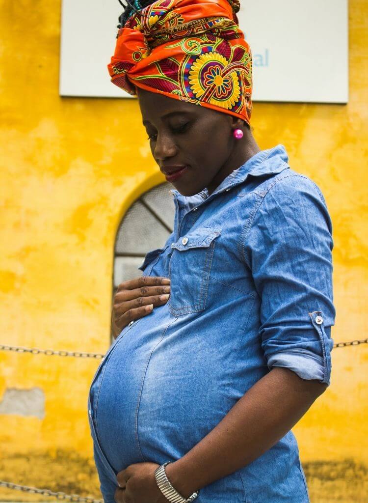Pregnant woman holding her belly